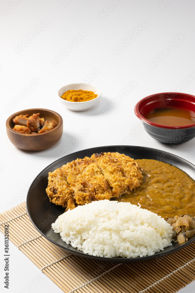 Tonkatsu Curry Rice (Japanese deep-fried pork cutlet with Curry rice) served with karaage (Japanese style fried chicken). on white background. Tonkatsu Curry Rice (Japanese deep-fried pork cutlet with Curry rice) served with karaage (Japanese style fried chicken). on white background.