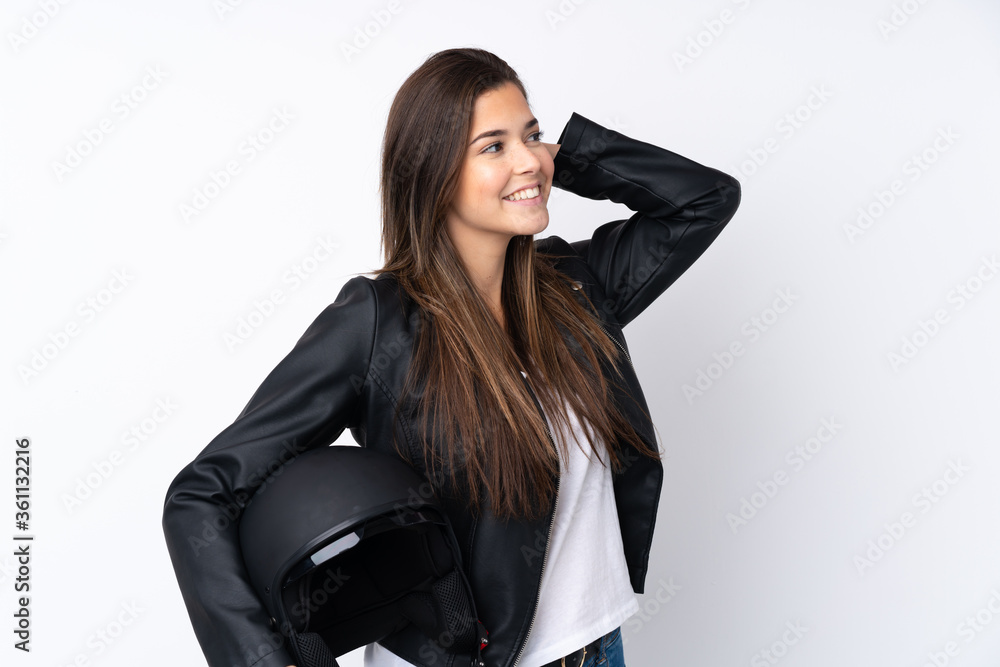 Young woman with a motorcycle helmet over isolated white background laughing Young woman with a motorcycle helmet over isolated white background laughing