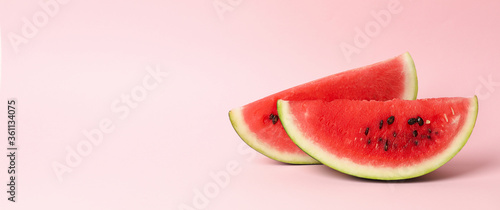 Slices of fresh watermelon on pink background. Summer fruit