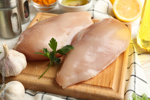 Raw chicken meat and ingredients on wooden background. Cooking chicken