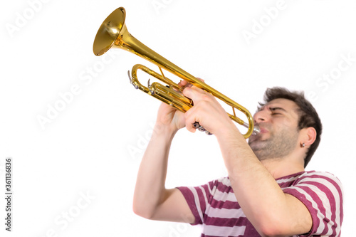 Trumpet player, plays the instrument, eyes are shut and blowing / isolated white background