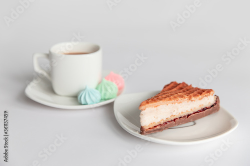 meringues, cake, sweets and a cup of coffee on a white background. Good morning.