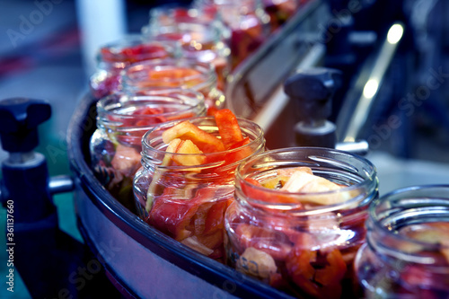 canned bell peppers on a curved conveyor line photo