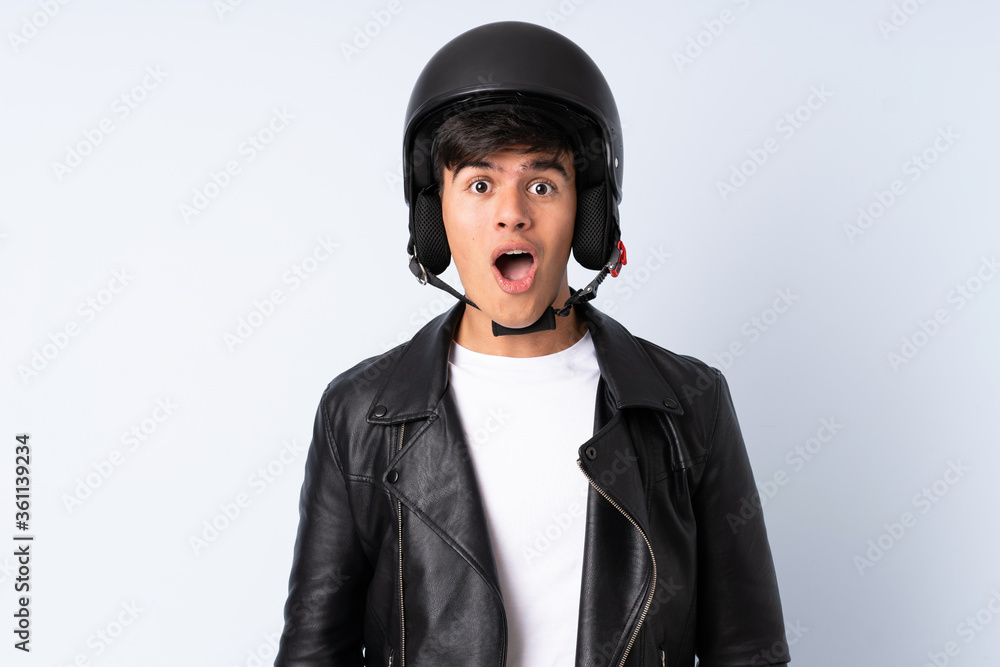 Man with a motorcycle helmet over isolated blue background Man with a motorcycle helmet over isolated blue background