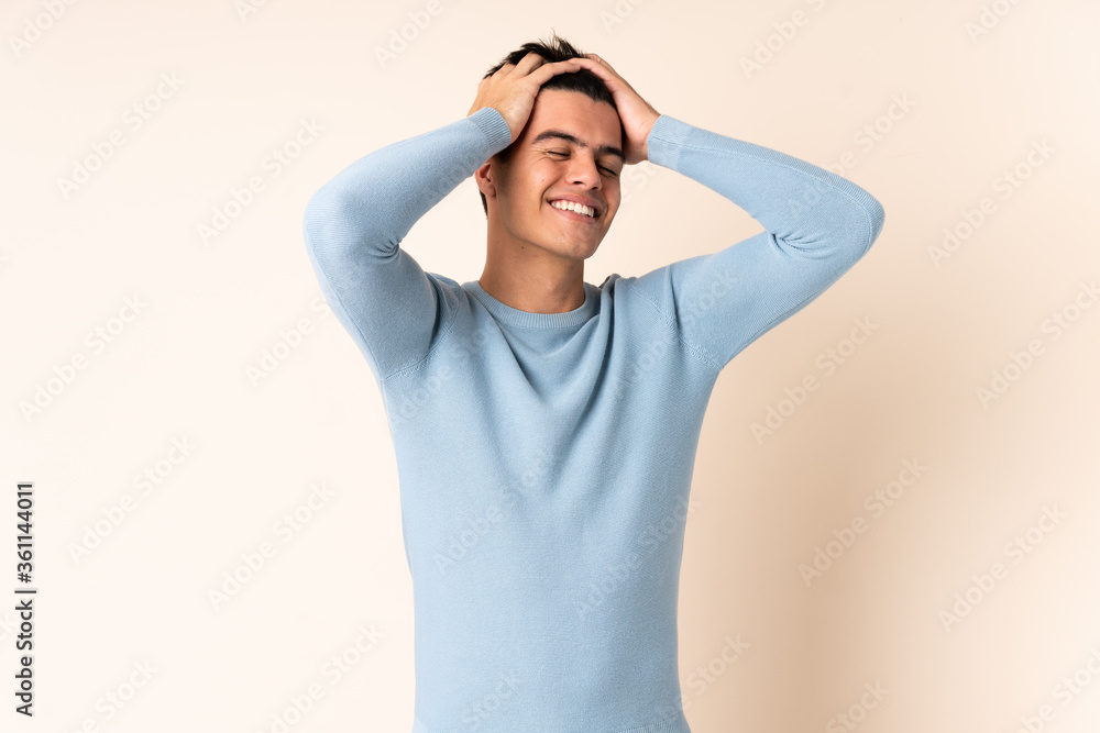 Handsome man over isolated beige background laughing Handsome man over isolated beige background laughing