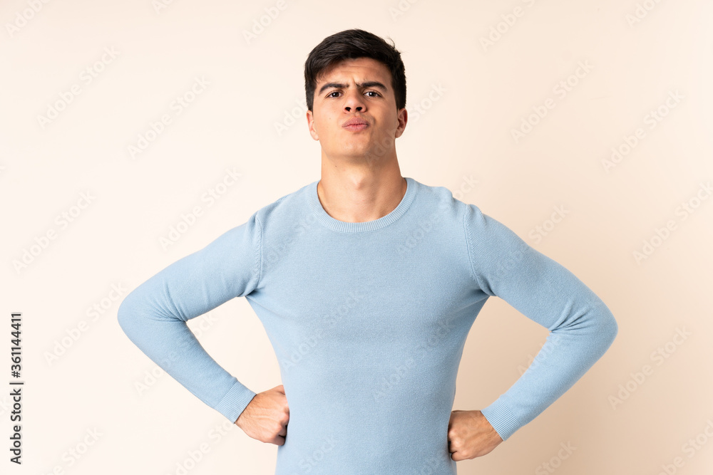 Handsome man over isolated beige background angry Handsome man over isolated beige background angry