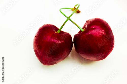 two isolated red ripe and sweet cherries.copy space