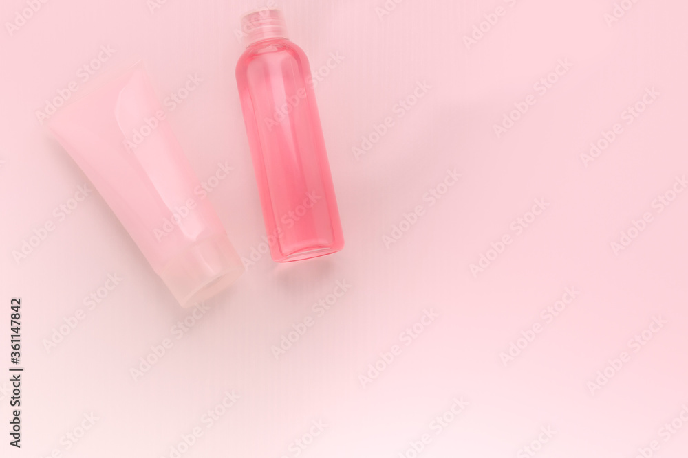 Cosmetics for beauty and hair care. Cleansing shampoo and nourishing and regenerating mask in a tube on a pink background Cosmetics for beauty and hair care. Cleansing shampoo and nourishing and regenerating mask in a tube on a pink background