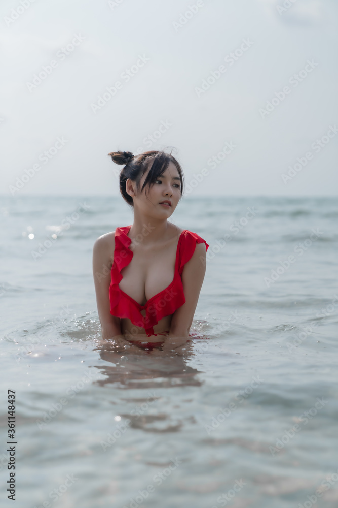 Young sexy woman in bikini enjoying summer vacation on beach relaxing holiday Young sexy woman in bikini enjoying summer vacation on beach relaxing holiday