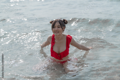 Young sexy woman in bikini enjoying summer vacation on beach relaxing holiday