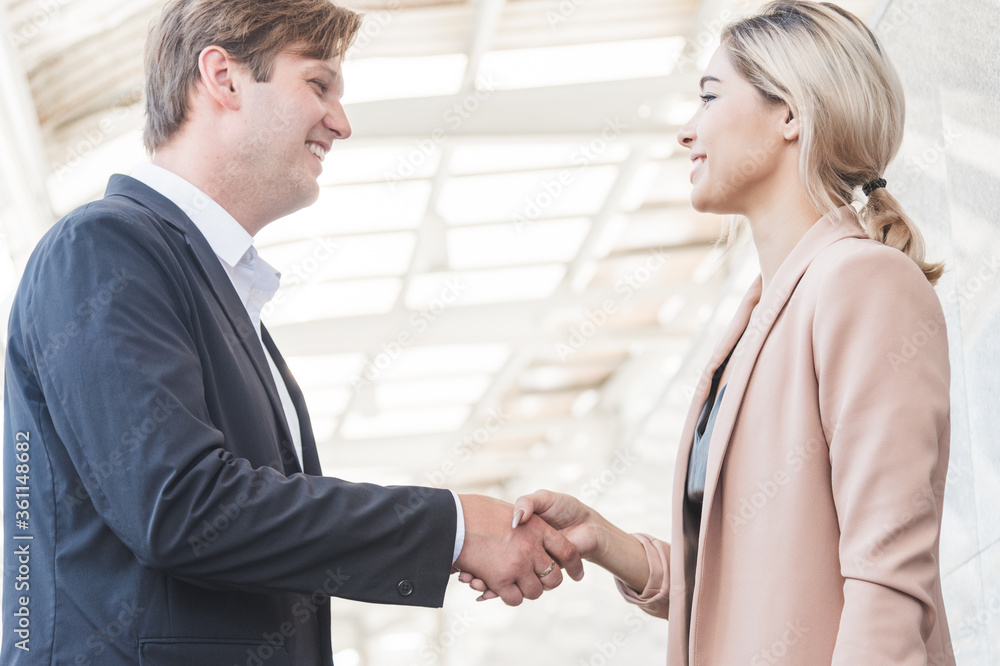 Business couple  smiling handshake with congratulation.
