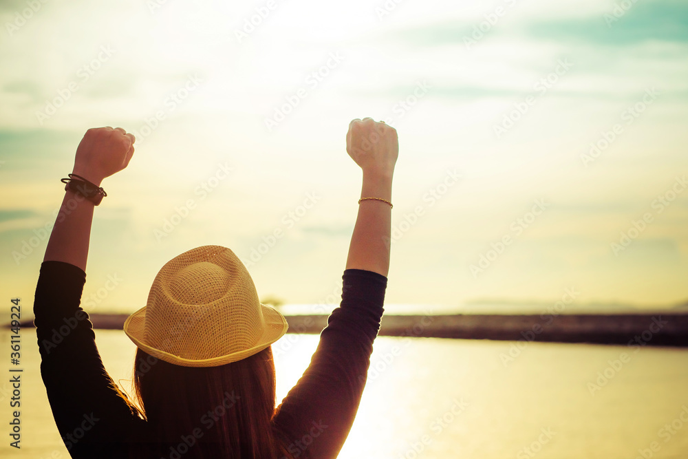 Fototapeta premium Close up of young woman enjoying victory and rise the hand and scream, enjoy success.