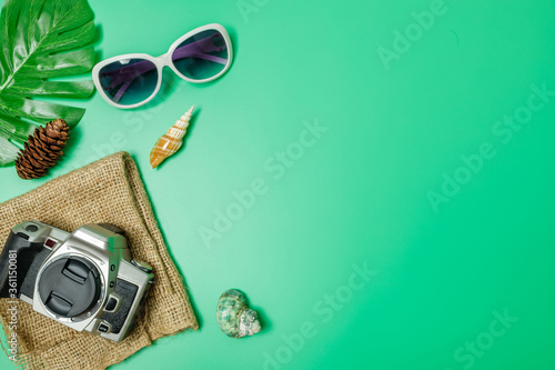 The beach accessories on the green background. Summer is coming concept. vacation and travel concept. photo