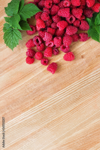 Sweet Raspberries on Wooden Background