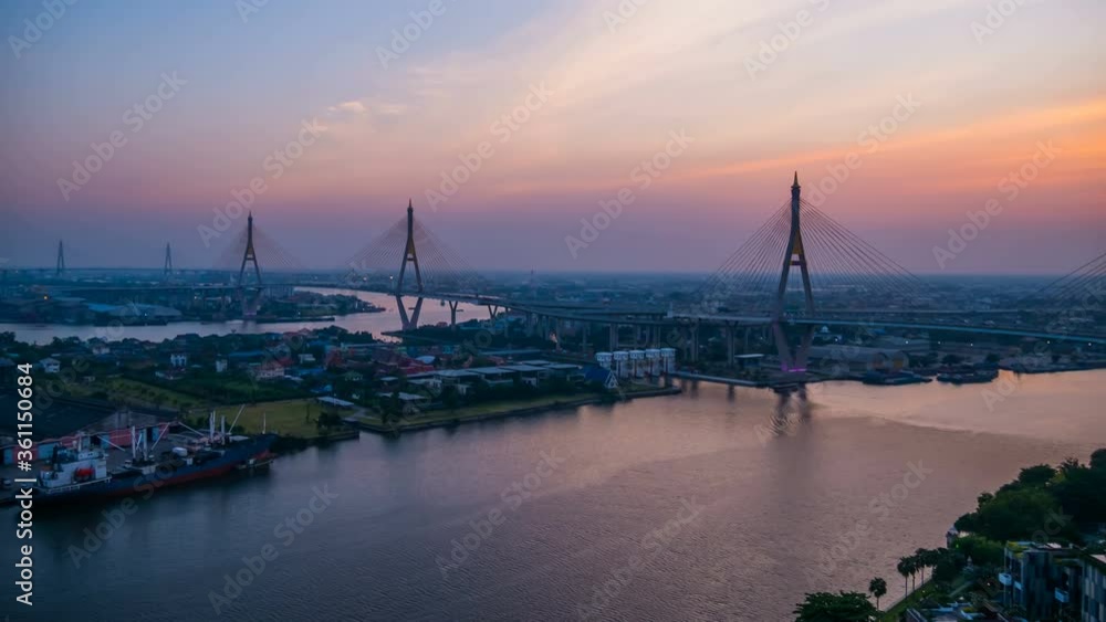 day to night time lapse of Bhumibol suspension bridge cross over Chao Phraya River at sunset in Bangkok city, Thailand day to night time lapse of Bhumibol suspension bridge cross over Chao Phraya River at sunset in Bangkok city, Thailand