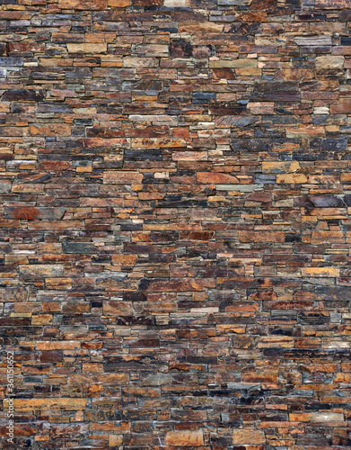 wall of dark brown, natural slate stone