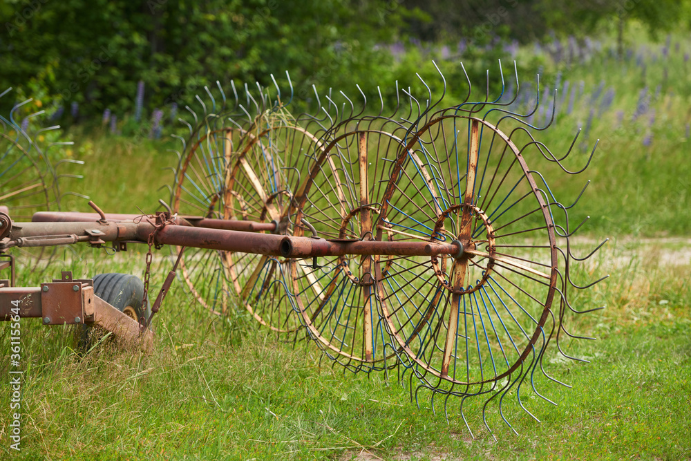 Old, solid technology. Spring tension on a star wheel rake. Old, solid technology. Spring tension on a star wheel rake.