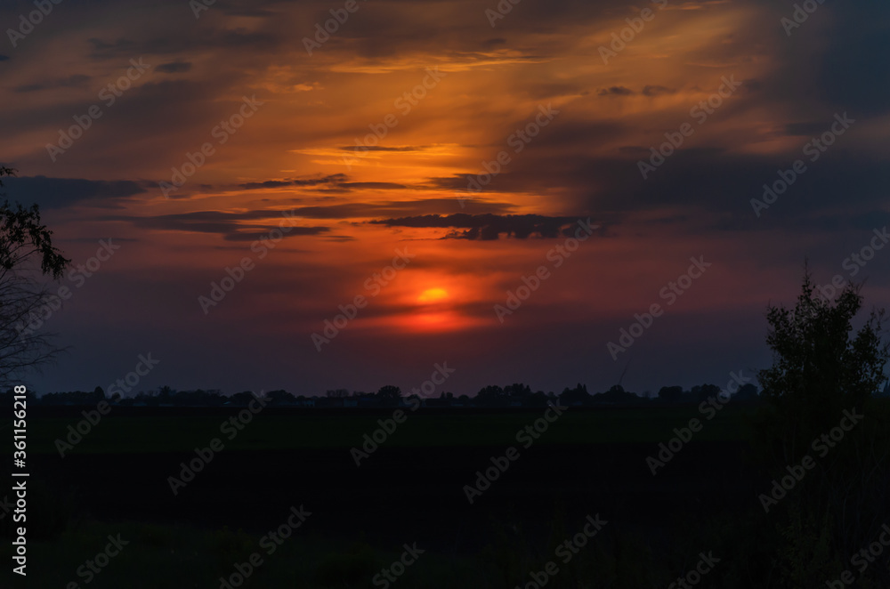 Fototapeta premium Sunset, bright colors in the sky and with clouds