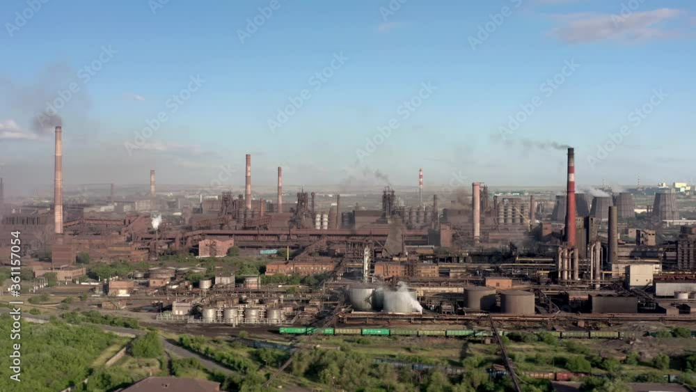 Industrial area in russian ural region, drone pan shot left to right. Aerial shot of garages, industrial plants, factory tubes on the horizon under grey cloudy sky Industrial area in russian ural region, drone pan shot left to right. Aerial shot of garages, industrial plants, factory tubes on the horizon under grey cloudy sky