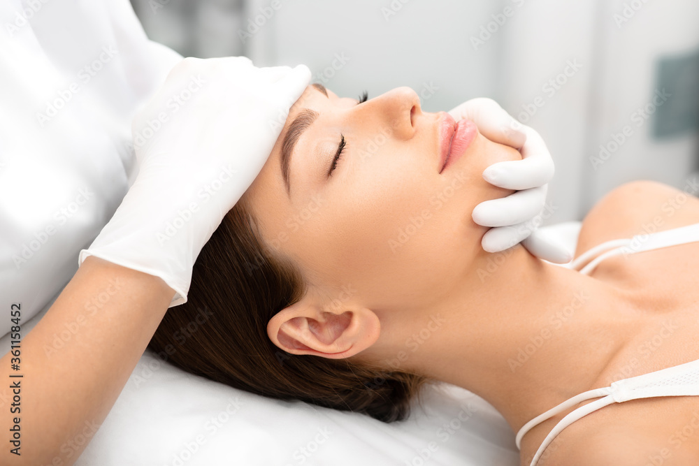 Beautiful woman, with smooth, shiny skin and a clean face, after peeling and skin rejuvenation at the beautician Beautiful woman, with smooth, shiny skin and a clean face, after peeling and skin rejuvenation at the beautician