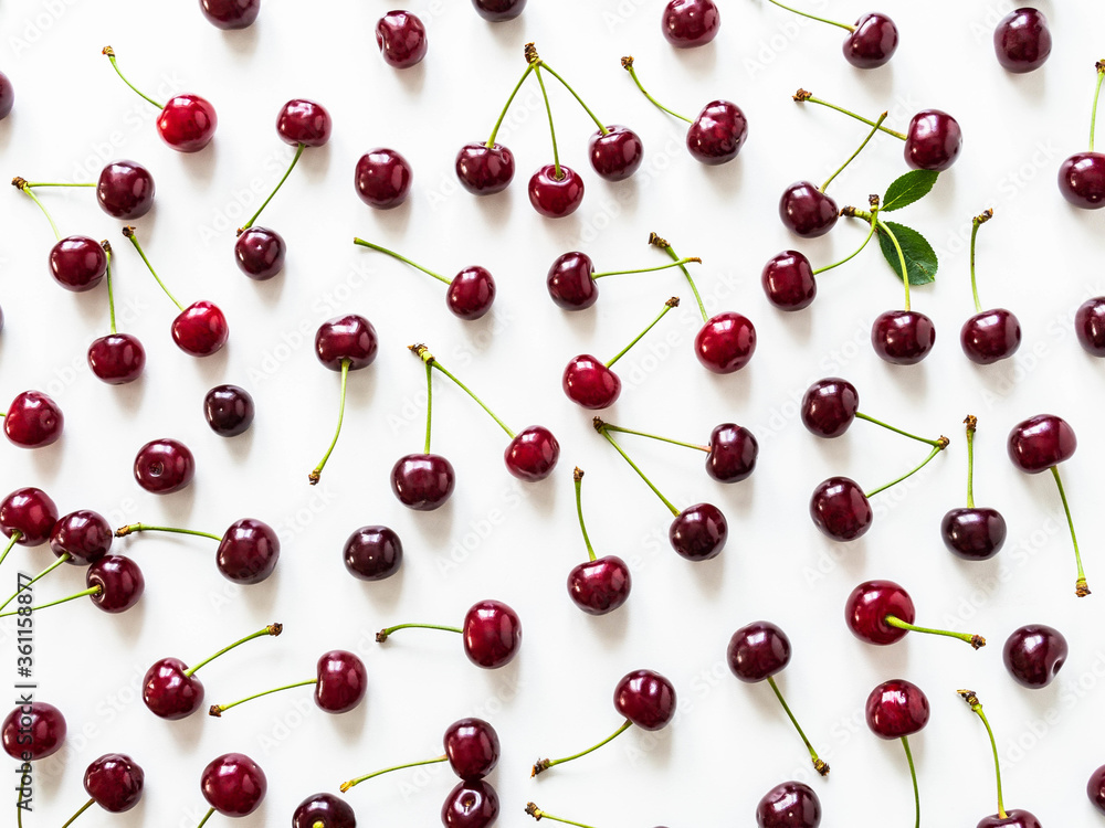 Large ripe cherry berries with leaves and drops of water background. Natural summer food background. Large ripe cherry berries with leaves and drops of water background. Natural summer food background.