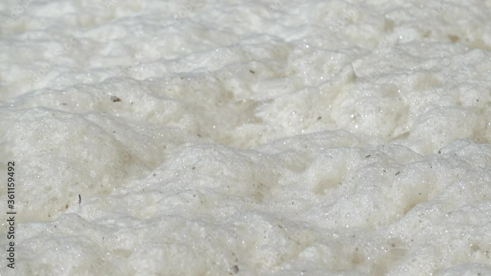 Sea foam Close Up on A Beach After The Night Storm. Natural Environment Sea foam Close Up on A Beach After The Night Storm. Natural Environment