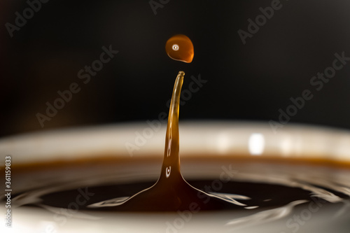 coffee splash and drop . macro close up brown liquid with smoke. photo