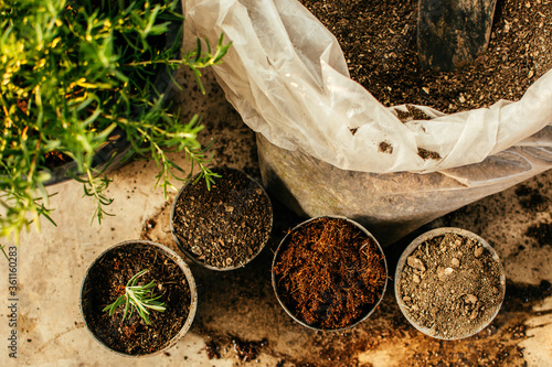 Material for planting seeds (soil, organic manure, coconut coir husk fiber) in plastic pots. Gardening and agriculture concept.