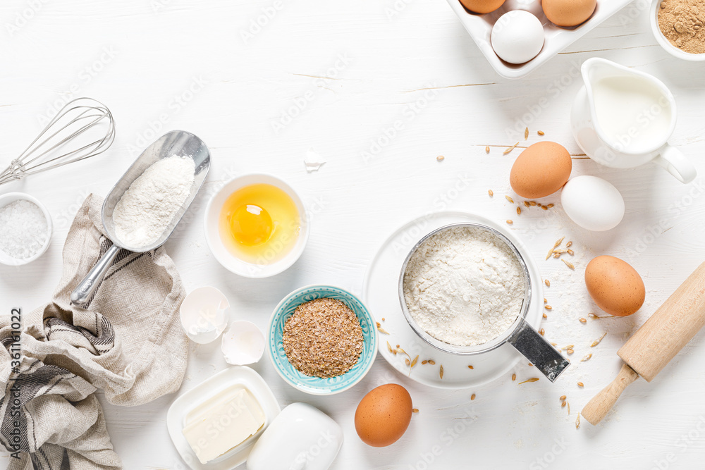 Baking homemade bread on white kitchen worktop with ingredients for cooking, culinary background, copy space, overhead view Baking homemade bread on white kitchen worktop with ingredients for cooking, culinary background, copy space, overhead view