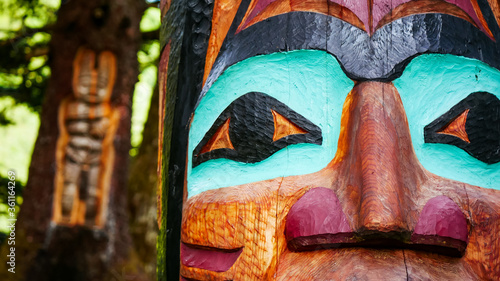 Фотография Closeup of colorful Alaskan totem pole in a forest in Juneau and Native art carv