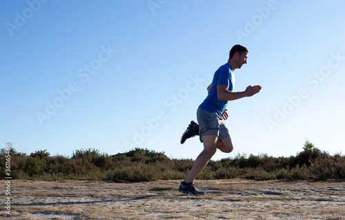 man sprinting in the countryside