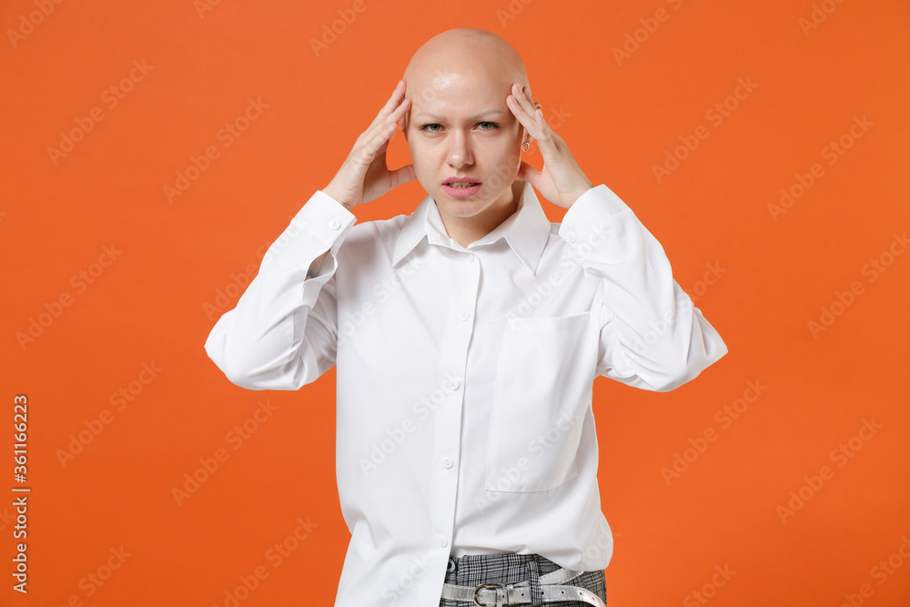 Displeased tired young bald business woman girl in white shirt posing isolated on orange background studio portrait. Achievement career wealth business concept. Mock up copy space. Put hand on head. Displeased tired young bald business woman girl in white shirt posing isolated on orange background studio portrait. Achievement career wealth business concept. Mock up copy space. Put hand on head.