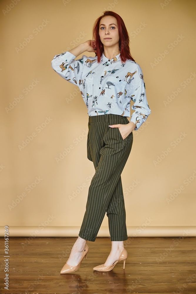 young business women on yellow background in green coctume young business women on yellow background in green coctume
