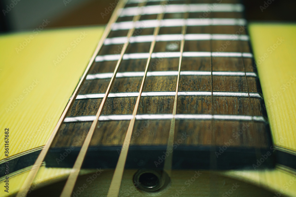 Close up of acoustic guitar with metal strings. Music concept Close up of acoustic guitar with metal strings. Music concept