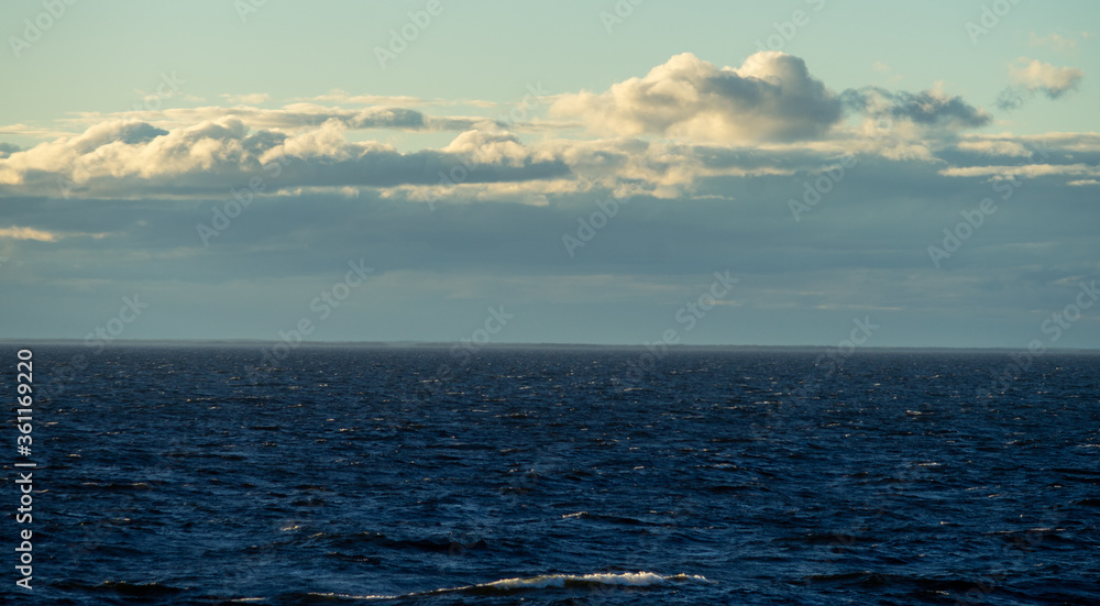 Fototapeta premium Small waves in the sea at sunset