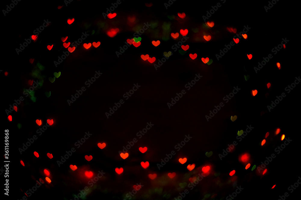 Valentine's day red bokeh hearts on black background