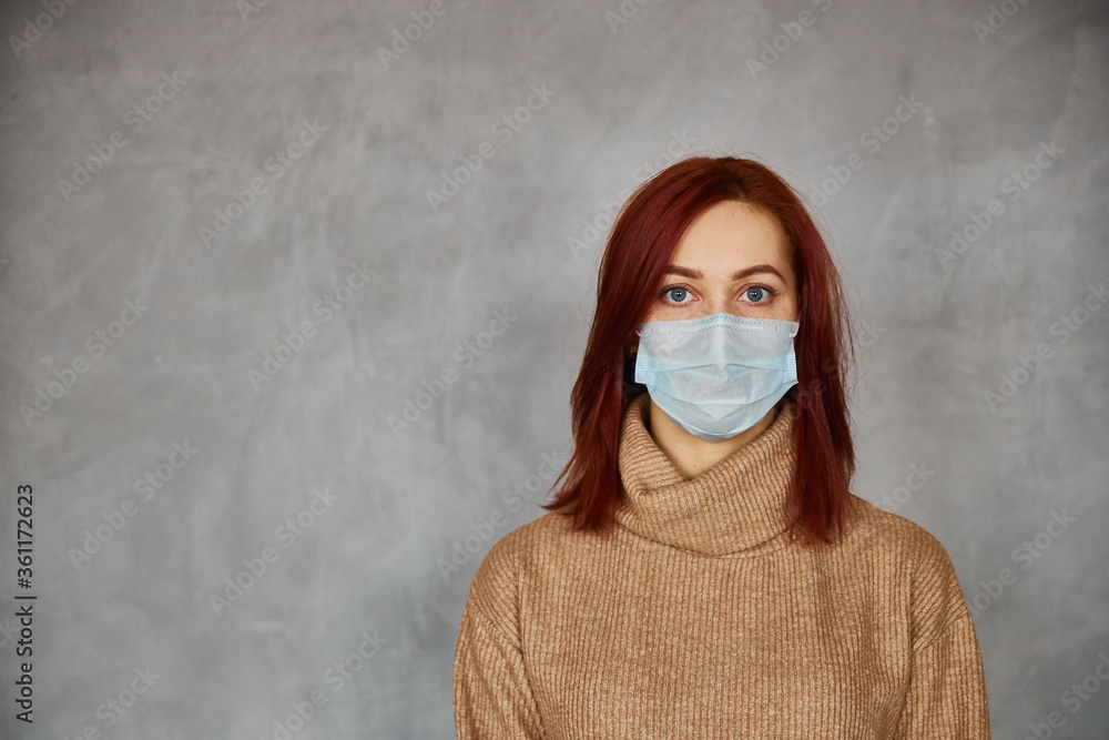 photo of beautiful young woman with mask on her face on the wonderful grey background photo of beautiful young woman with mask on her face on the wonderful grey background