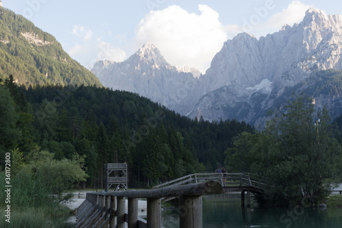 Lake, mountains and a wooden bridge.
