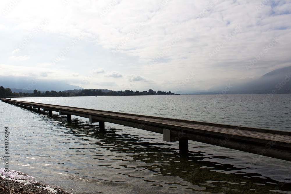 wooden pier with water horizon in mountain lake  