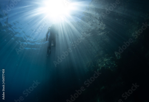 Beautiful girl swimming and freediving in the blue crystal clear mediterranean sea