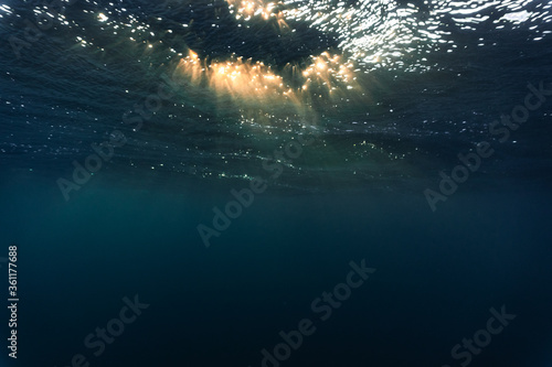 Rays of light shining through the surface of the atlantic ocean, into the deep, blue and dark abyss © Snorre