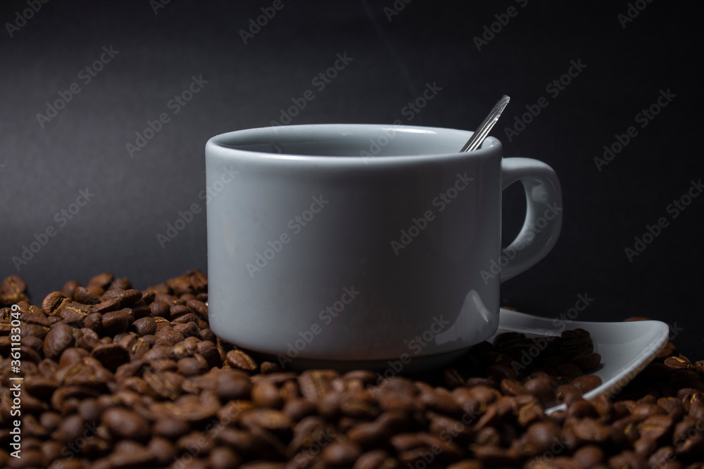 Coffee cup and coffee beans on black background Coffee cup and coffee beans on black background