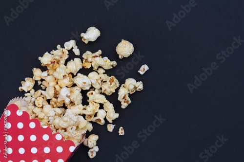 Red popcorn box on black background with copy space