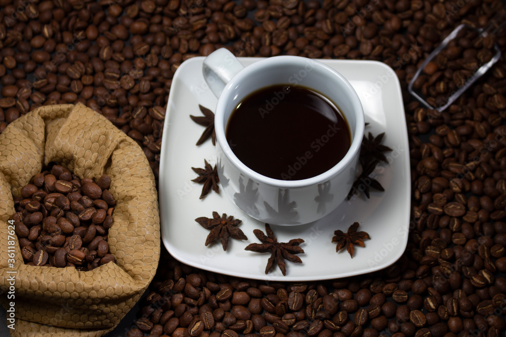 Coffee cup and coffee beans on black background Coffee cup and coffee beans on black background