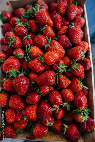 Ripe fresh strawberries close-up in a container for sale. Healthy diet photo