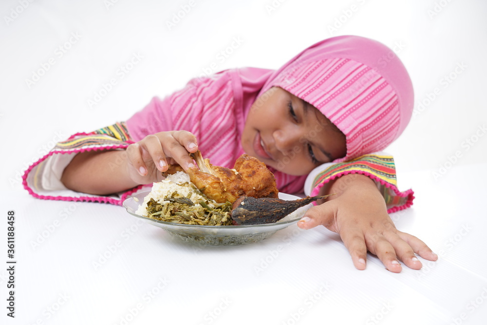 Asian Muslim girl eating Fried Chicken for lunch