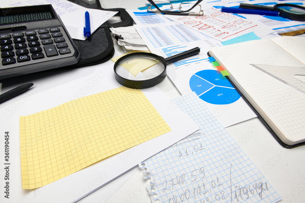business office desk closeup - financial reports, analysis and accounting, set of documents, tables and graphs, various items for bookkeeping, calculator business office desk closeup - financial reports, analysis and accounting, set of documents, tables and graphs, various items for bookkeeping, calculator