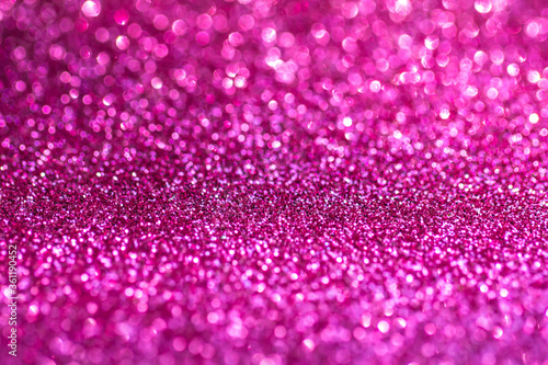 Background of sequins. Sequins in the background. Pink purple sparkling background. Festive abstract shiny background with flashing lights. The fabric glitters with bright colors. Fashionable fabrics 