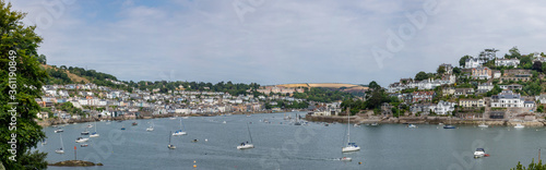 Wide panoramic shot of the River Dart with Kingswear in the background. Boats on the river Dart in Dartmouth, South Devon. The town of Kingswear can be seen in the background.