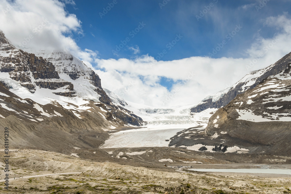 The Athabasca Glacier in the Columbia Icefield in Alberta, Canada. The scale can be seen middle left by the trucks and people on the glacier.